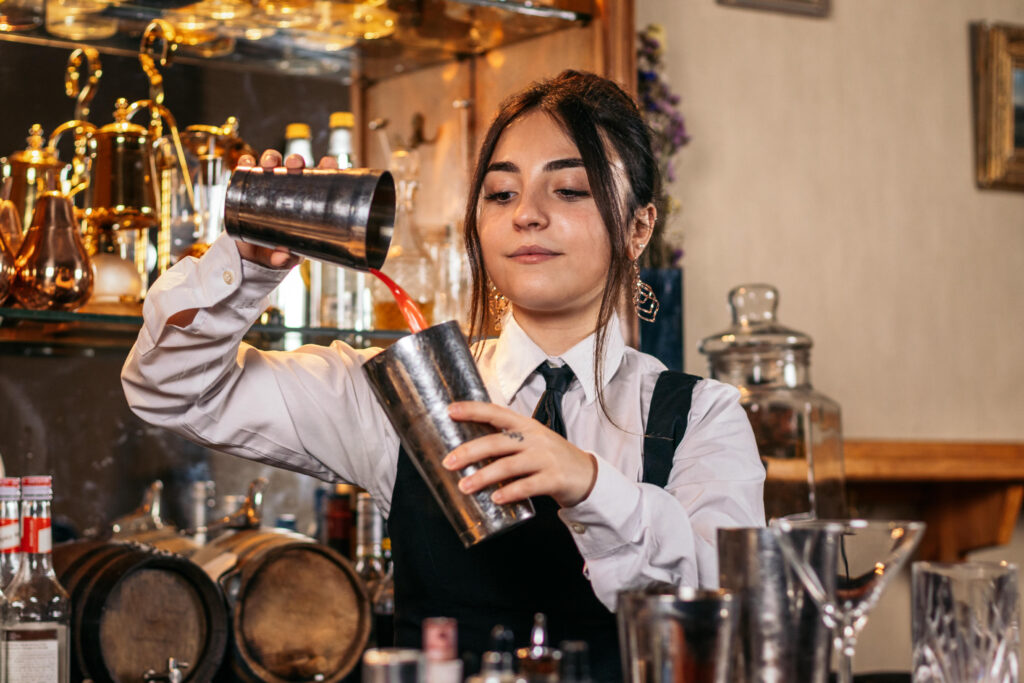 Kvinnlig bartender förbereder cocktail bartenderutbildning Stockholm