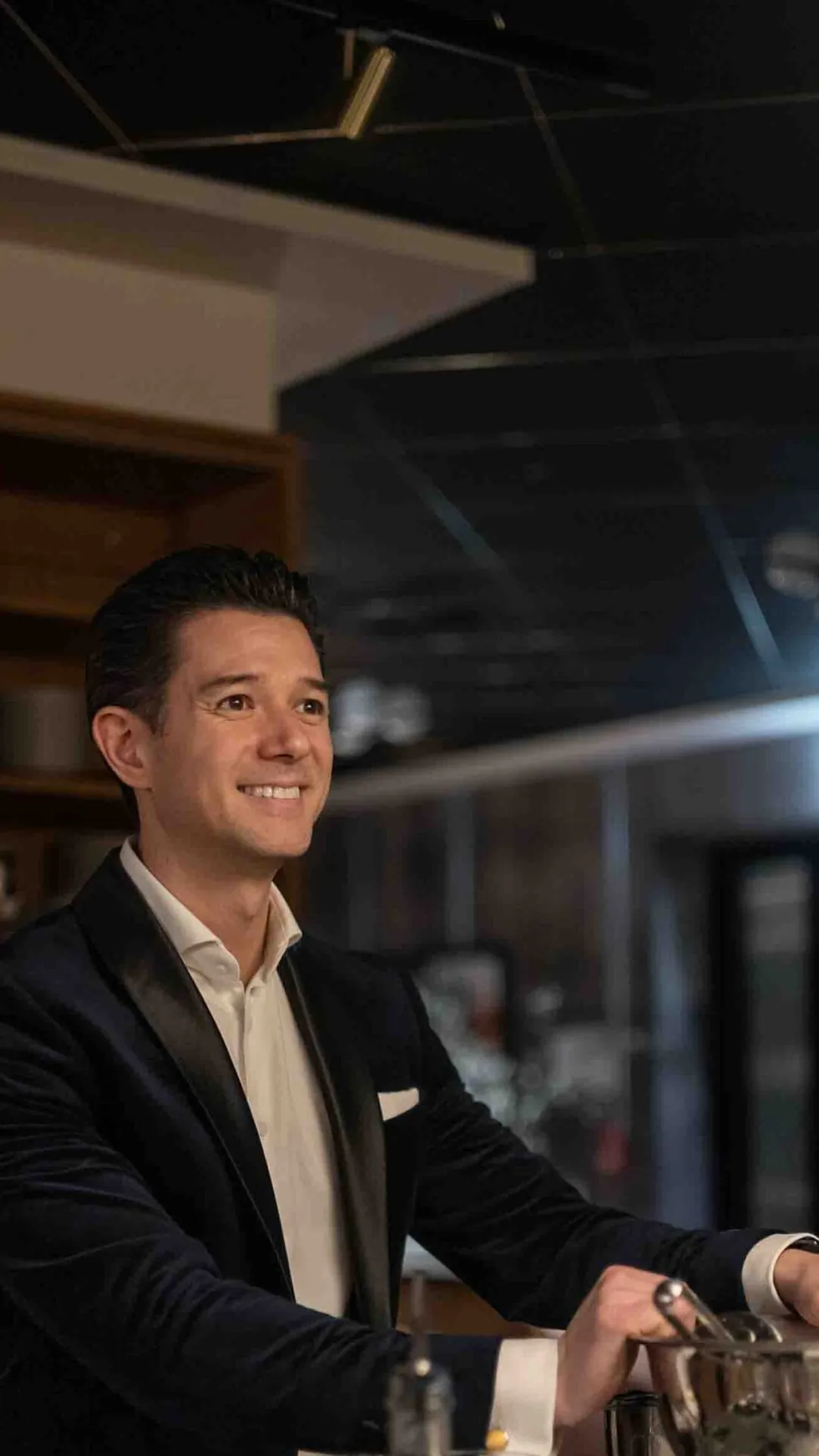 Deltagare i kavaj blandar en drink vid baren